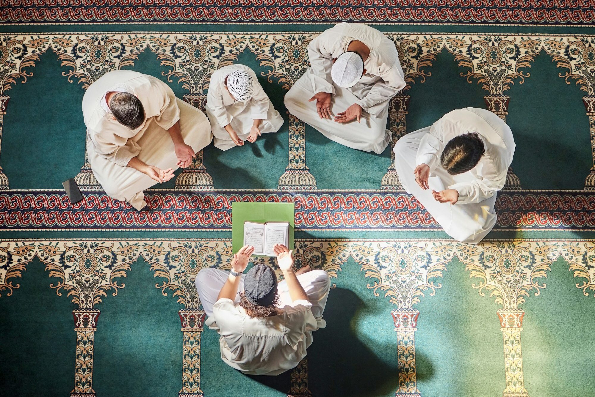 Above mosque carpet, group and quran for faith, religion and prayer for gratitude, peace or mindful